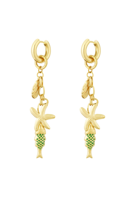 Pair of gold-tone drop earrings featuring starfish, seashell and green enamel fish charms on white background