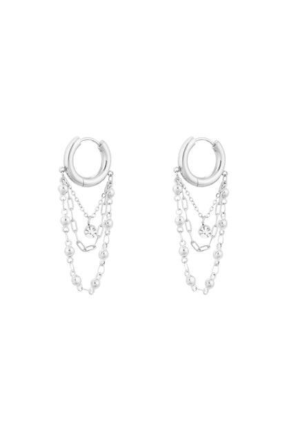 Silver chained hoop drop earrings with triple chains and rhinestone charm on white background