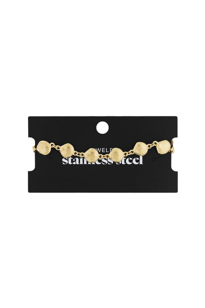 Gold seashell charm bracelet displayed on black jewelry card with white text, showing stainless steel material.