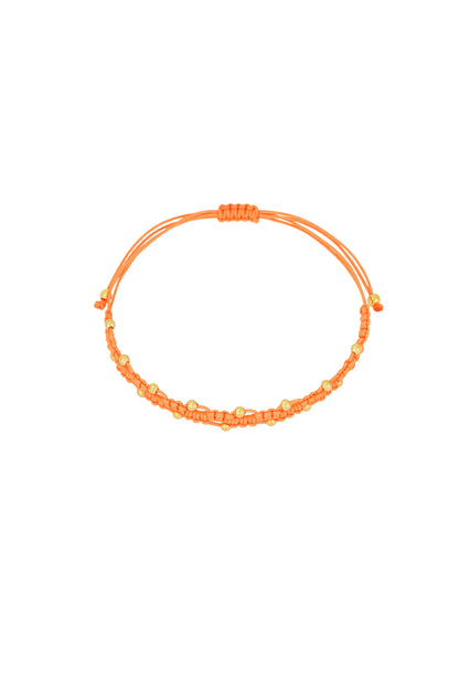 Close-up of orange braided bead bracelet on white background