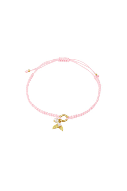 Light pink braided bracelet featuring gold mermaid tail charm and pearl bead on white background