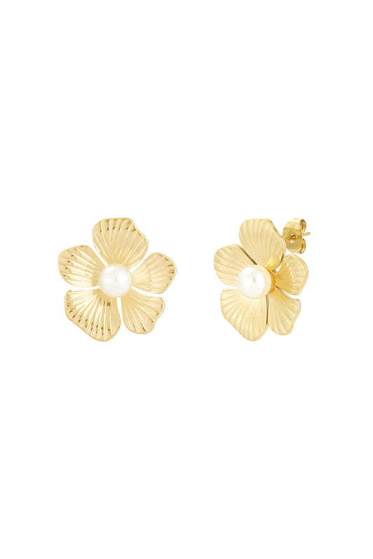 Close-up of gold-tone flower-shaped stud earrings with a central white pearl on a white background