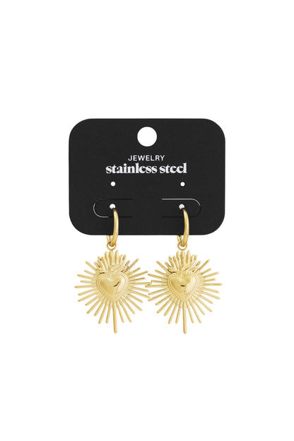 Gold Milagros heart sunburst earrings displayed on black jewelry card labeled stainless steel