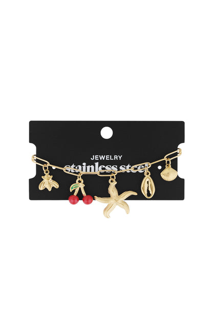 Gold charm bracelet displayed on black jewelry card with stainless steel text, showing all charms distinctively