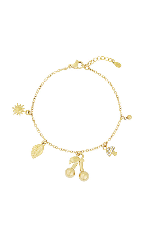 Gold charm bracelet with pendants sun, leaf, cherries and crystal mushroom on white background