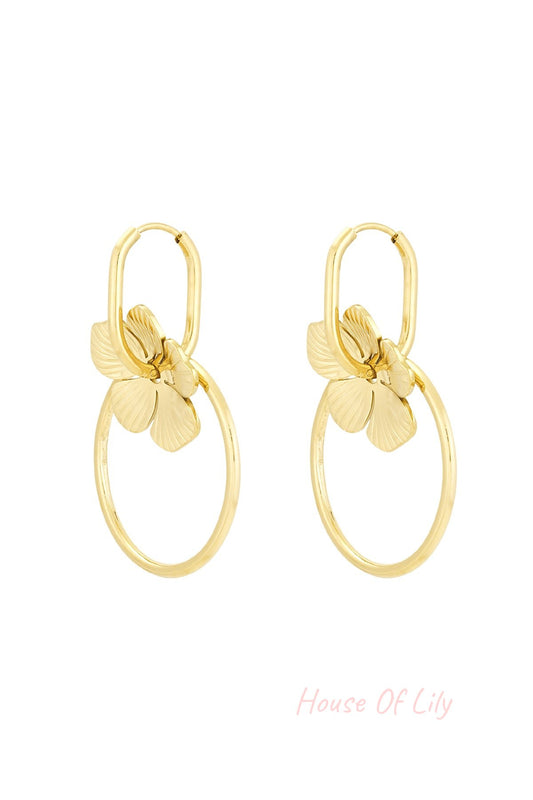 Pair of gold-tone floral hoop drop earrings with flower charms and circular hoops on white background