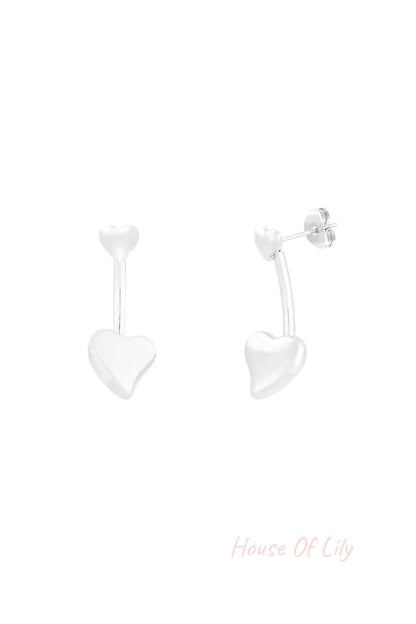 Close-up of silver double heart drop earrings with small heart stud and larger heart drop