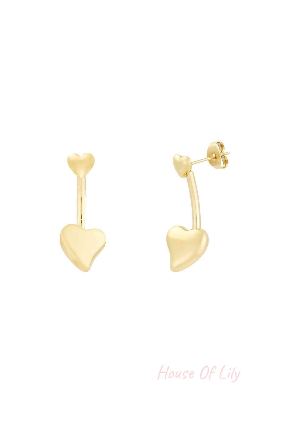Close-up of gold double heart drop earrings with small heart stud and larger heart drop