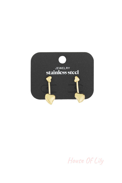 Gold double heart drop earrings displayed on black stainless steel jewelry card