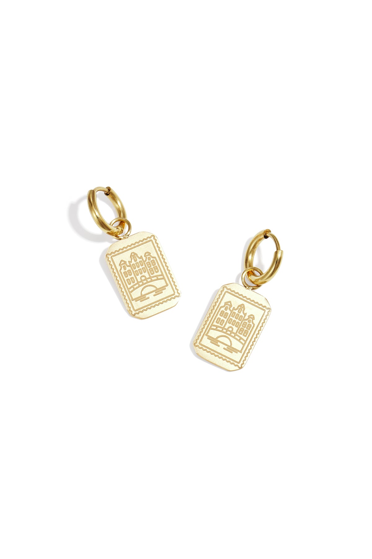 Pair of gold drop earrings featuring rectangular pendants with etched Amsterdam canal house design on a white background.