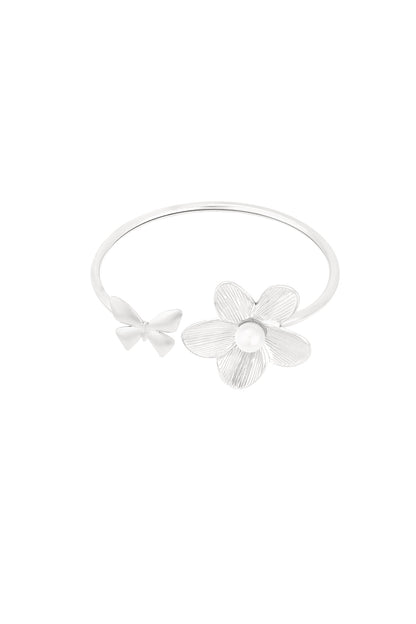 Silver cuff bracelet with butterfly and flower design featuring a pearl center on white background