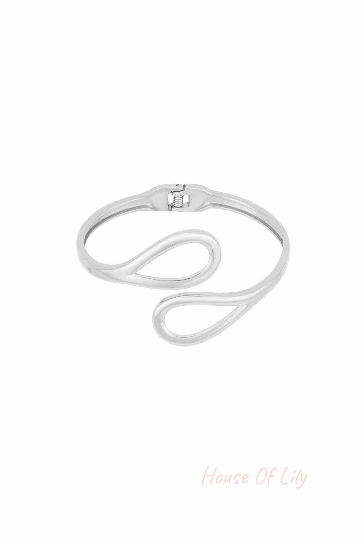 Silver-toned cuff bracelet with open loop design on white background