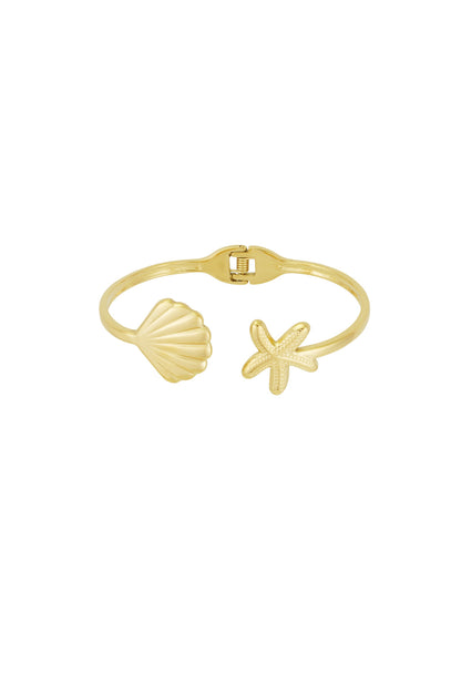 Gold cuff bracelet with starfish and seashell charms on each end against white background