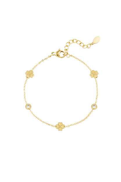 Gold bracelet with four-leaf clover charms and crystal accents displayed flat on a white background