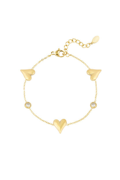 Gold tone stainless steel bracelet with three heart charms and two round crystal accents