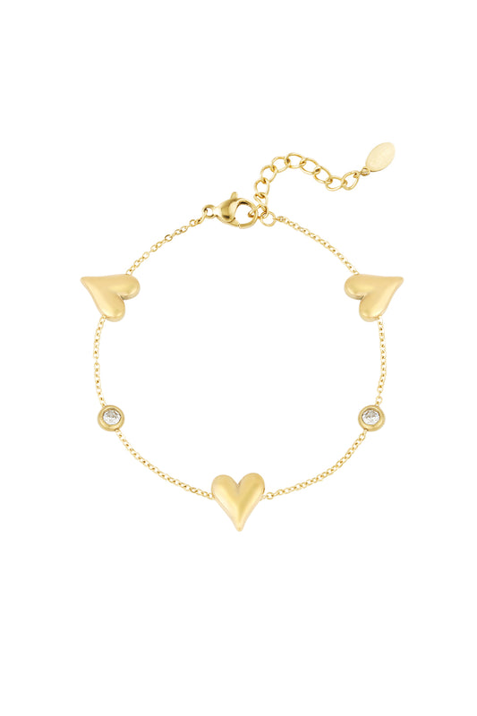 Gold tone stainless steel bracelet with three heart charms and two round crystal accents