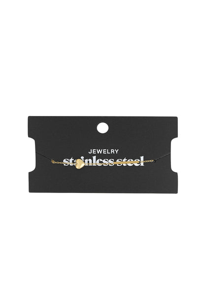 Gold heart charm bracelet displayed on black jewellery card labelled 'stainless steel'