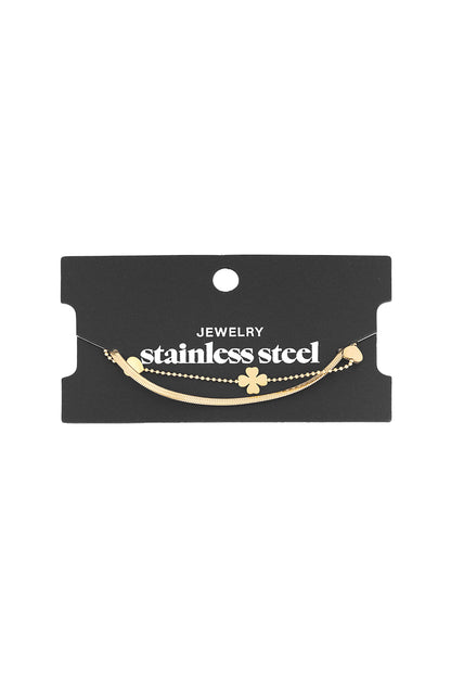 Gold layered charm bracelet displayed on a black card labelled stainless steel jewellery