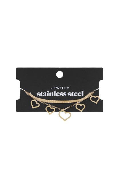 Heart charm bracelet in gold displayed on black retail card with stainless steel label