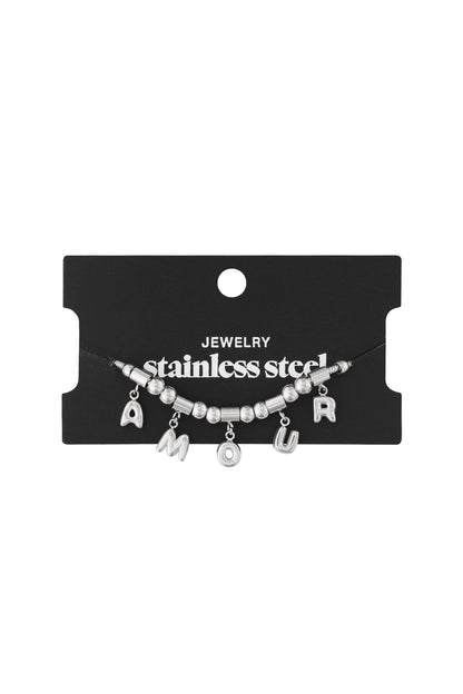 Silver stainless steel AMOUR charm bracelet displayed on black jewellery card with white writing