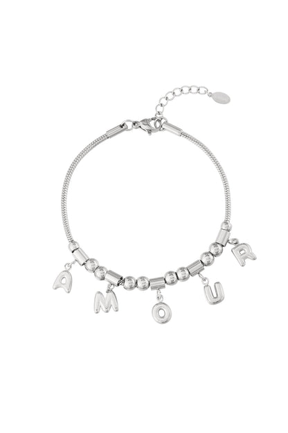 Silver stainless steel charm bracelet with AMOUR letter charms and beaded chain on a white background