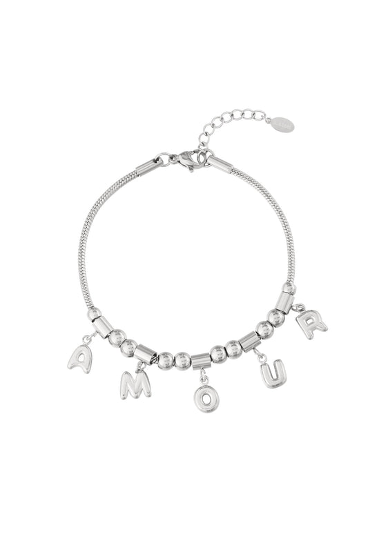 Silver stainless steel charm bracelet with AMOUR letter charms and beaded chain on a white background