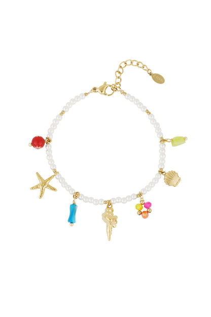Charmed pearl bracelet with starfish, shell, coral, and colorful bead charms against a white background