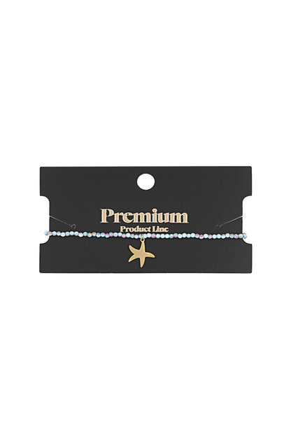 Beaded starfish bracelet displayed on a black card labeled Premium Product Line, showcasing the gold starfish charm and light blue beads.