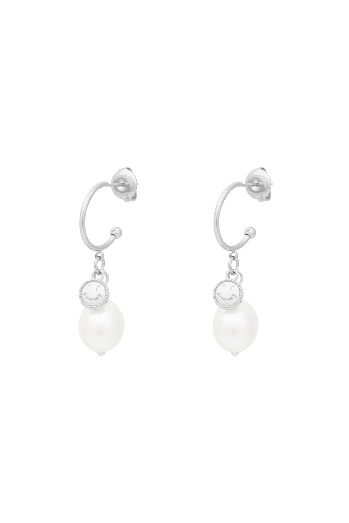 Pair of silver-tone hoop drop earrings featuring a small smiley charm and a white pearl drop against a white background