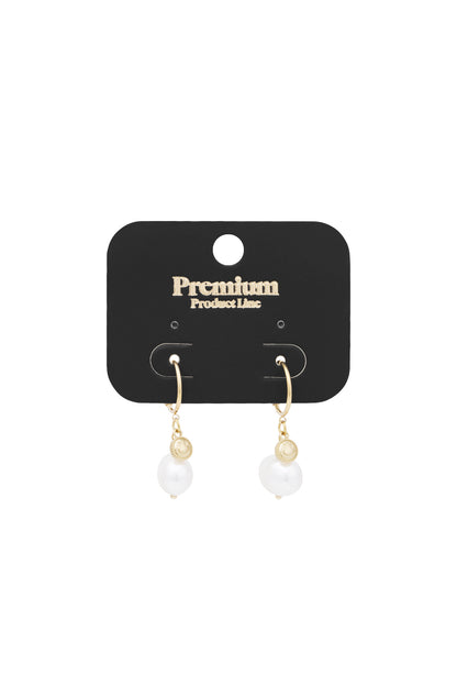 Gold-tone Happy Glow drop earrings displayed on a black premium product line card