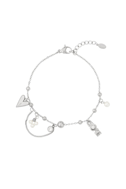 Silver-tone delicate charm bracelet featuring heart, pearl clusters, and LOVE lettering charm isolated on white background