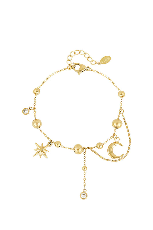Gold celestial charm bracelet with moon, star, and bead charms on white background