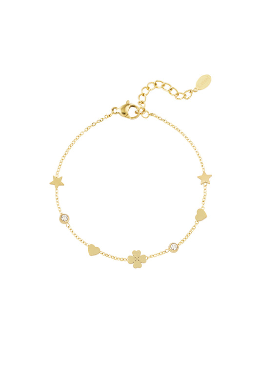 Gold-tone delicate charm bracelet featuring tiny stars, hearts, four-leaf clover and crystal accents on a fine chain with adjustable clasp