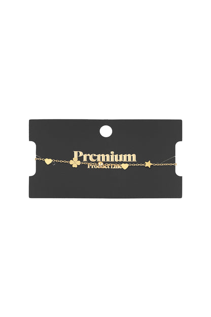 Gold-tone charm bracelet displayed on black premium product card showing delicate star, heart, clover and crystal charms on fine chain