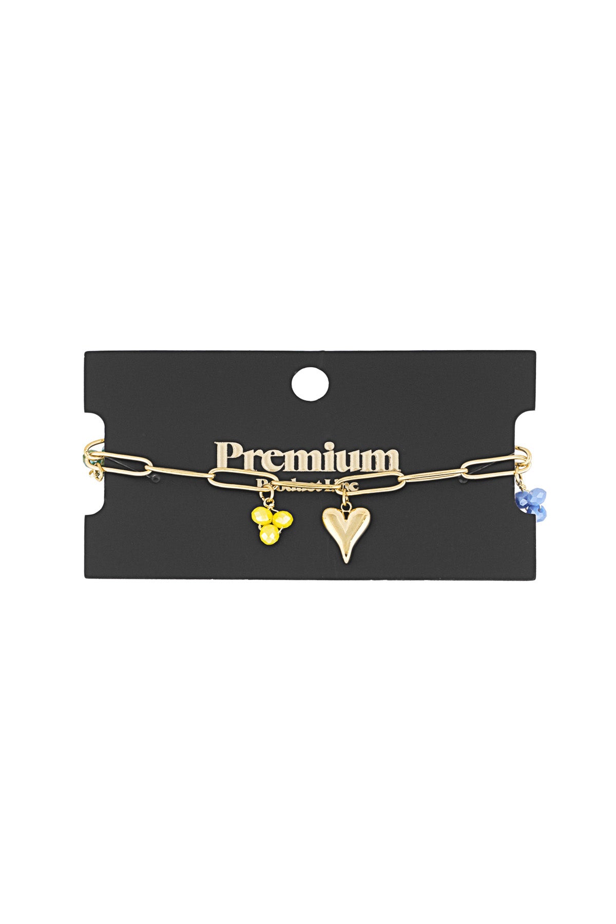 Gold charm bracelet displayed on premium black jewellery card showing yellow and blue bead charms with heart charm