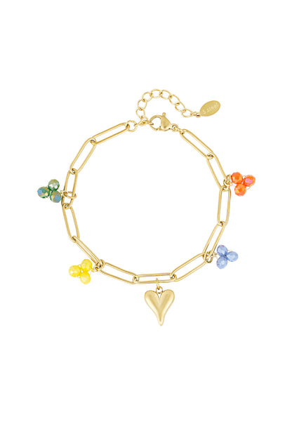Gold charm link bracelet with multi-coloured glass bead charms and heart-shaped charm on white background