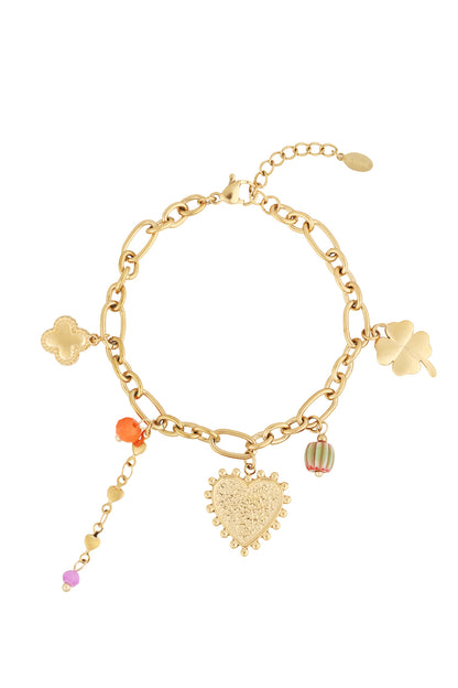 Gold charm bracelet with heart, four-leaf clover, flower-shaped, and colourful bead charms on a lobster clasp chain