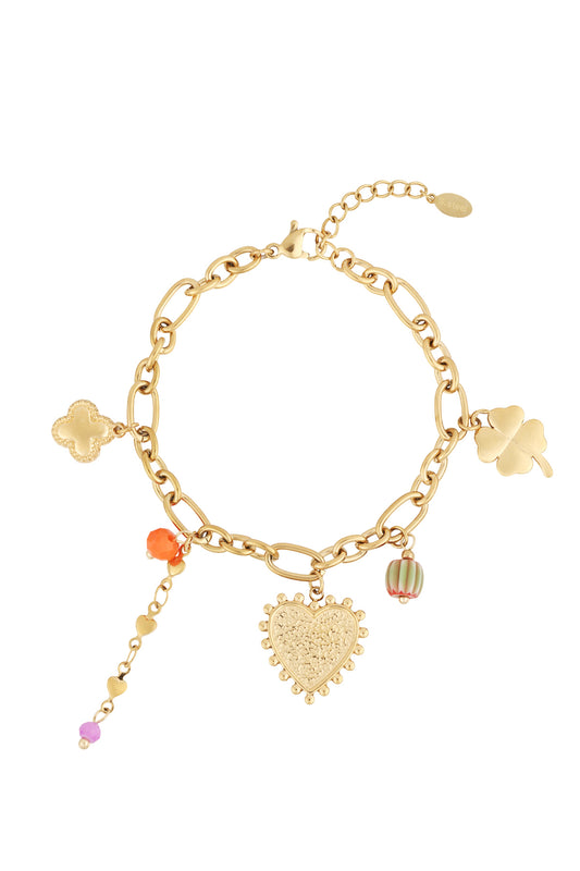 Gold charm bracelet with heart, four-leaf clover, flower-shaped, and colourful bead charms on a lobster clasp chain