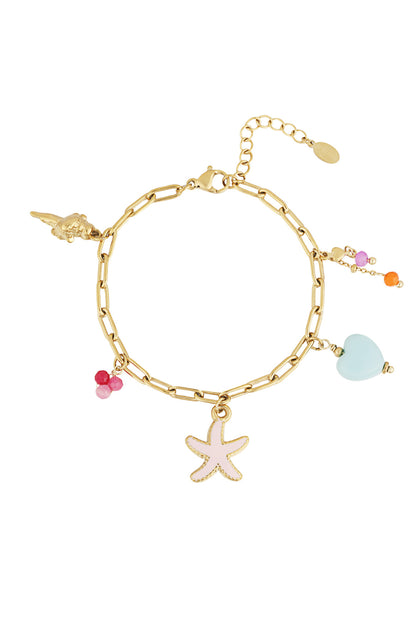 Gold chain charm bracelet featuring pink starfish, turquoise heart, gold seashell and tiny colourful bead charms on white background