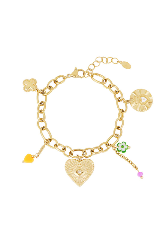 Gold charm bracelet with five unique charms including a textured heart with eye and crystal, orange heart, green flower, gold four-leaf, and round heart disc on white background