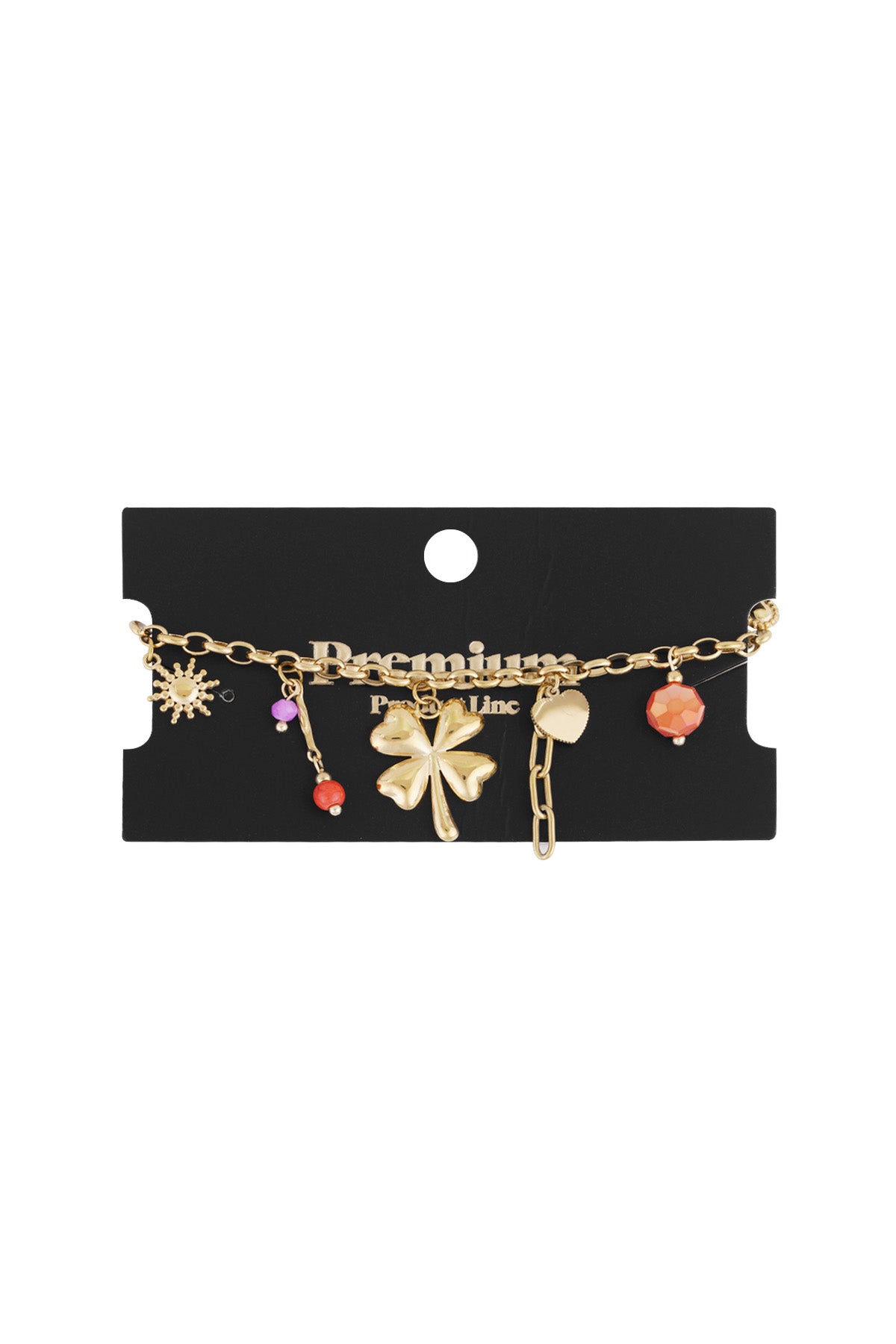 Gold charm bracelet displayed on black Premium packaging card