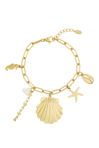 Golden chain-link charm bracelet laid flat showing shell, starfish, seahorse, cowrie shell, and pearl cluster charms