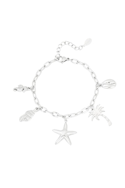 Silver beach charm bracelet with starfish, palm tree, seashell, seahorse and cowrie shell charms on textured link chain