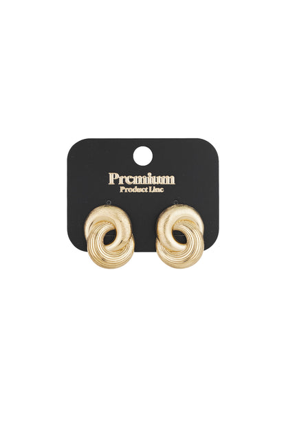 Gold twist statement stud earrings displayed on black premium product card packaging