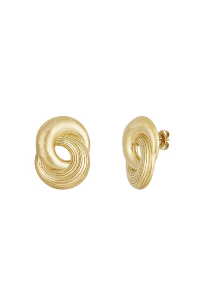 Close-up of a pair of gold twist statement stud earrings with smooth and grooved texture