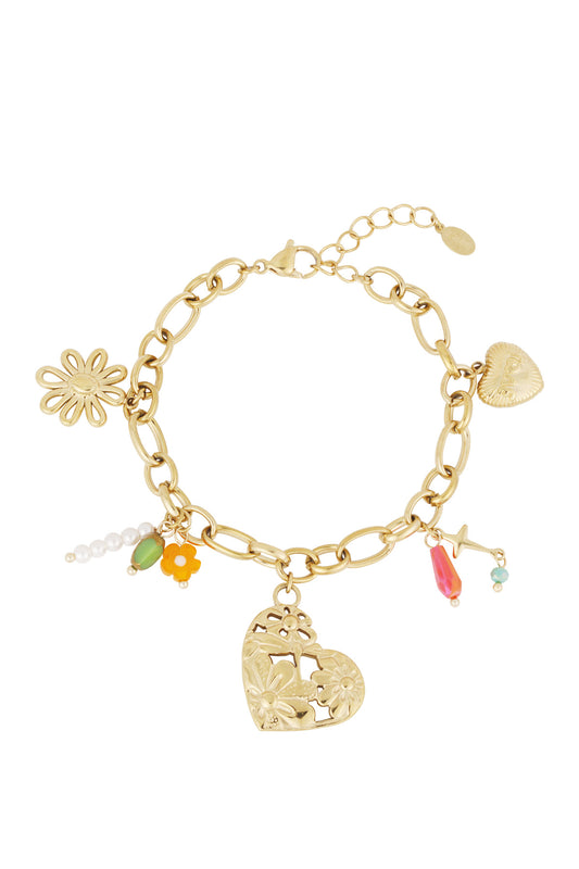 Gold-tone link bracelet with multiple charms including floral heart, daisy flower, star, and colourful beads laid flat on white background