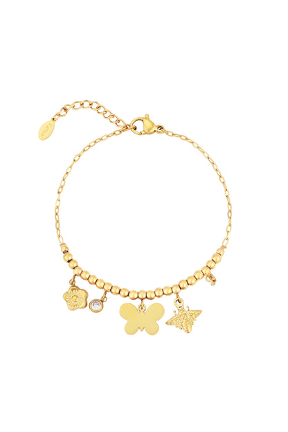 Gold-toned beaded bracelet with butterfly, bee, flower, and crystal charms displayed flat on white background