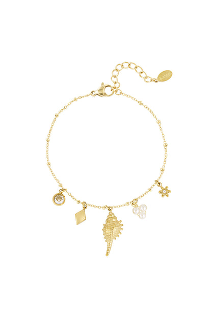 Gold-tone charm bracelet with crystal, rhombus, seashell, pearl, and flower charms on a white background
