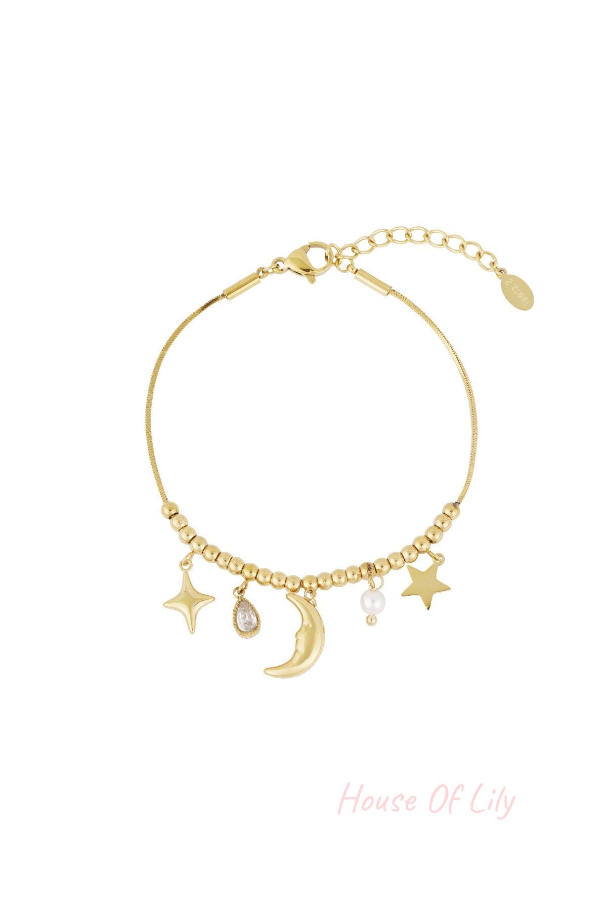 Gold celestial charm bracelet with moon, stars, pearl, and teardrop crystal charms on a beaded chain with adjustable clasp