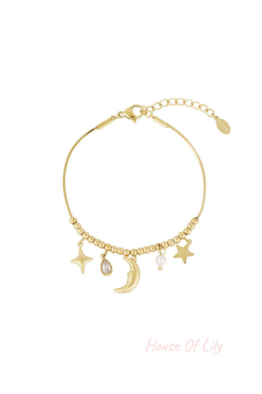 Gold celestial charm bracelet with moon, stars, pearl, and teardrop crystal charms on a beaded chain with adjustable clasp